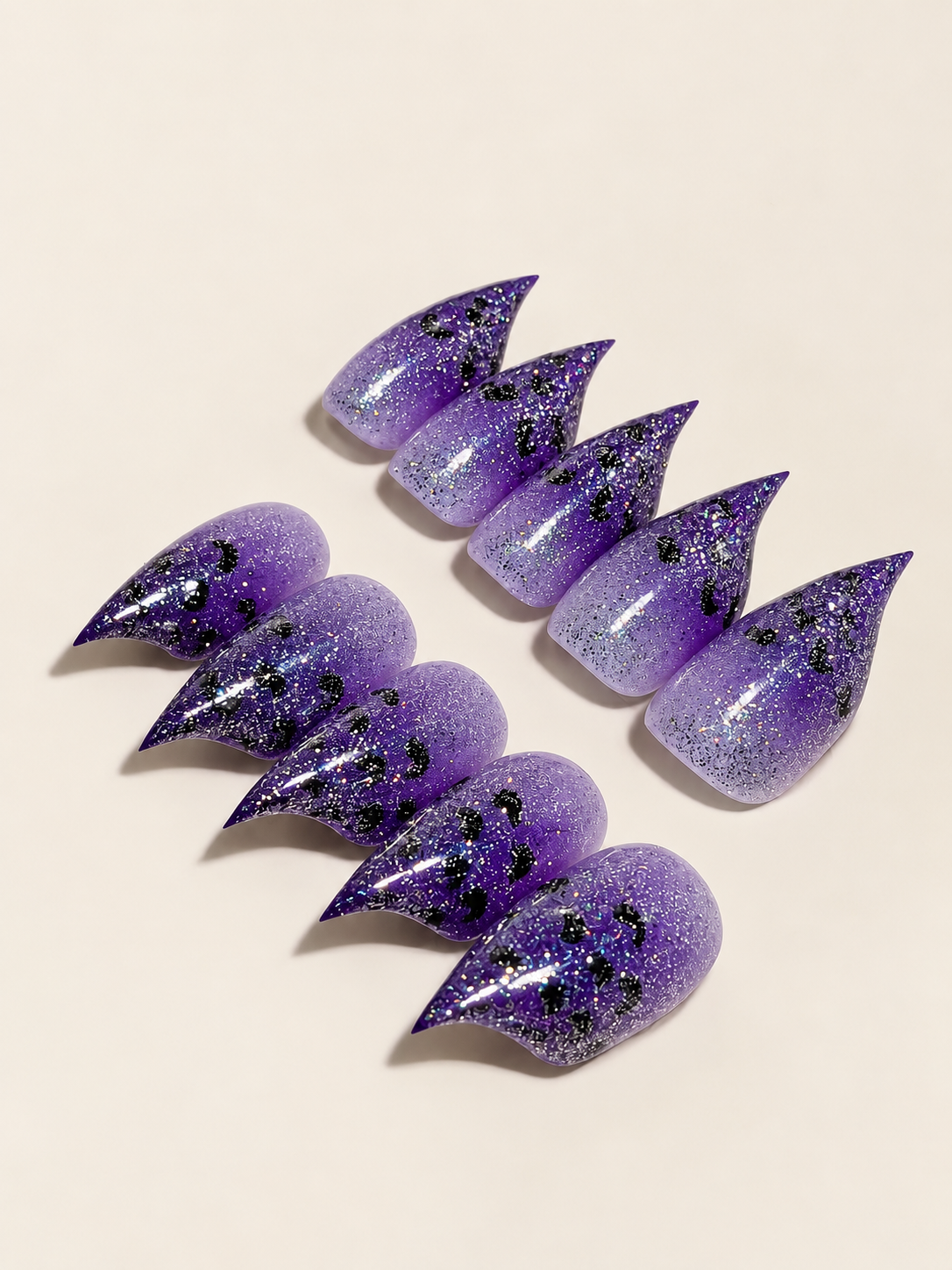 Side-angle view of purple glitter leopard stiletto press-on nails
