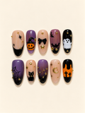 Ten Halloween almond press-on nails in purple, peach, orange, and black with a pumpkin, ghost, black cat, bats, spiderweb, and gold accents