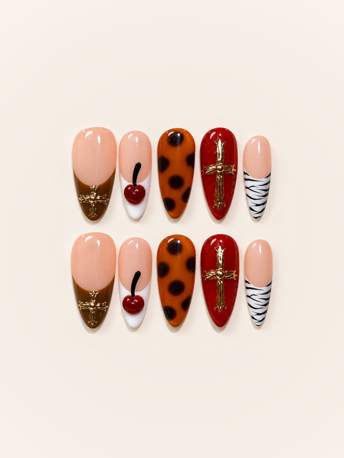 OVANA nude, cherry red, and tortoiseshell press-on nails with gold crosses and a cherry accent