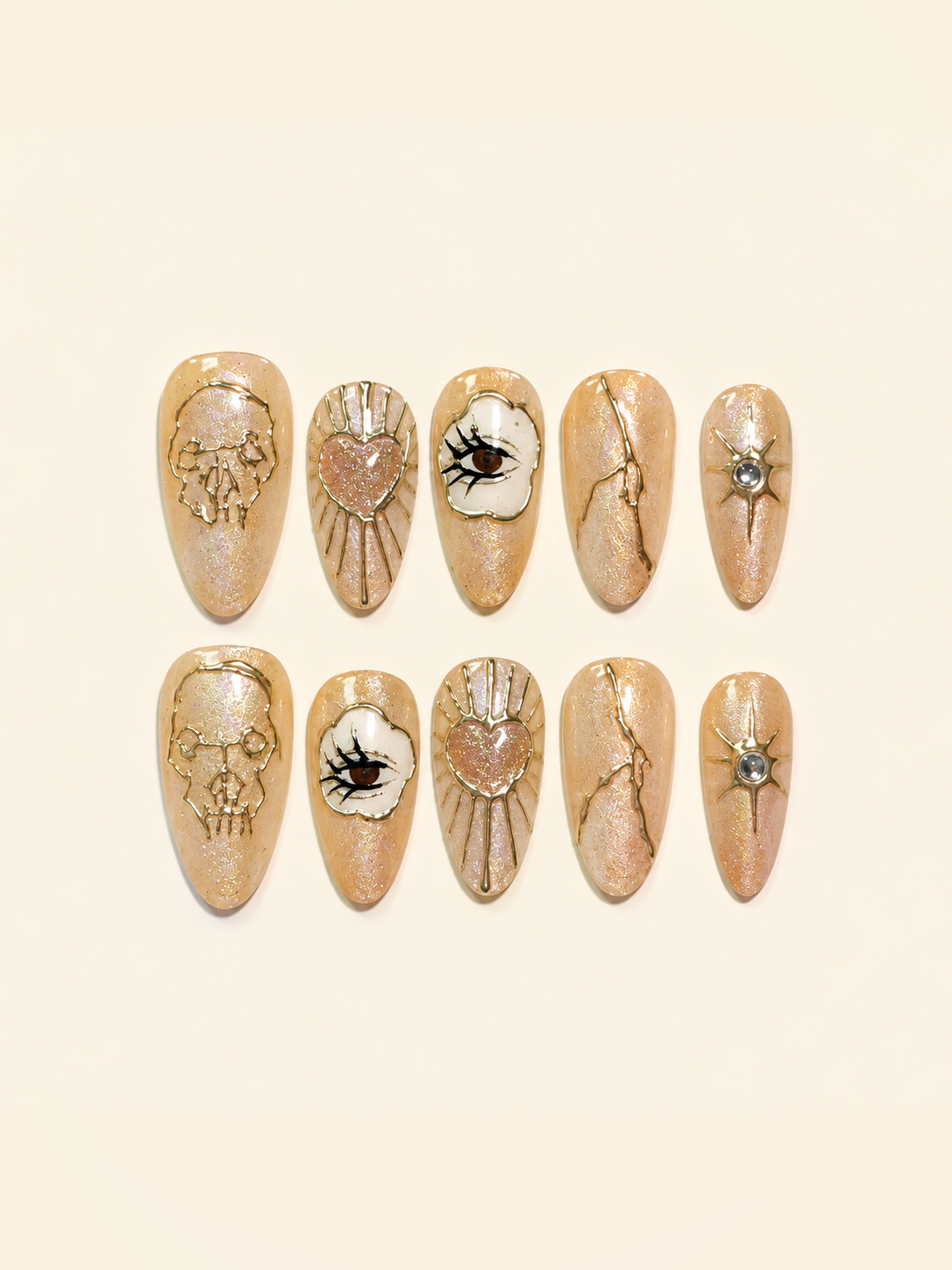 OVANA peach-gold Halloween press-on nails with sculpted skull, eye, heart, and star motifs