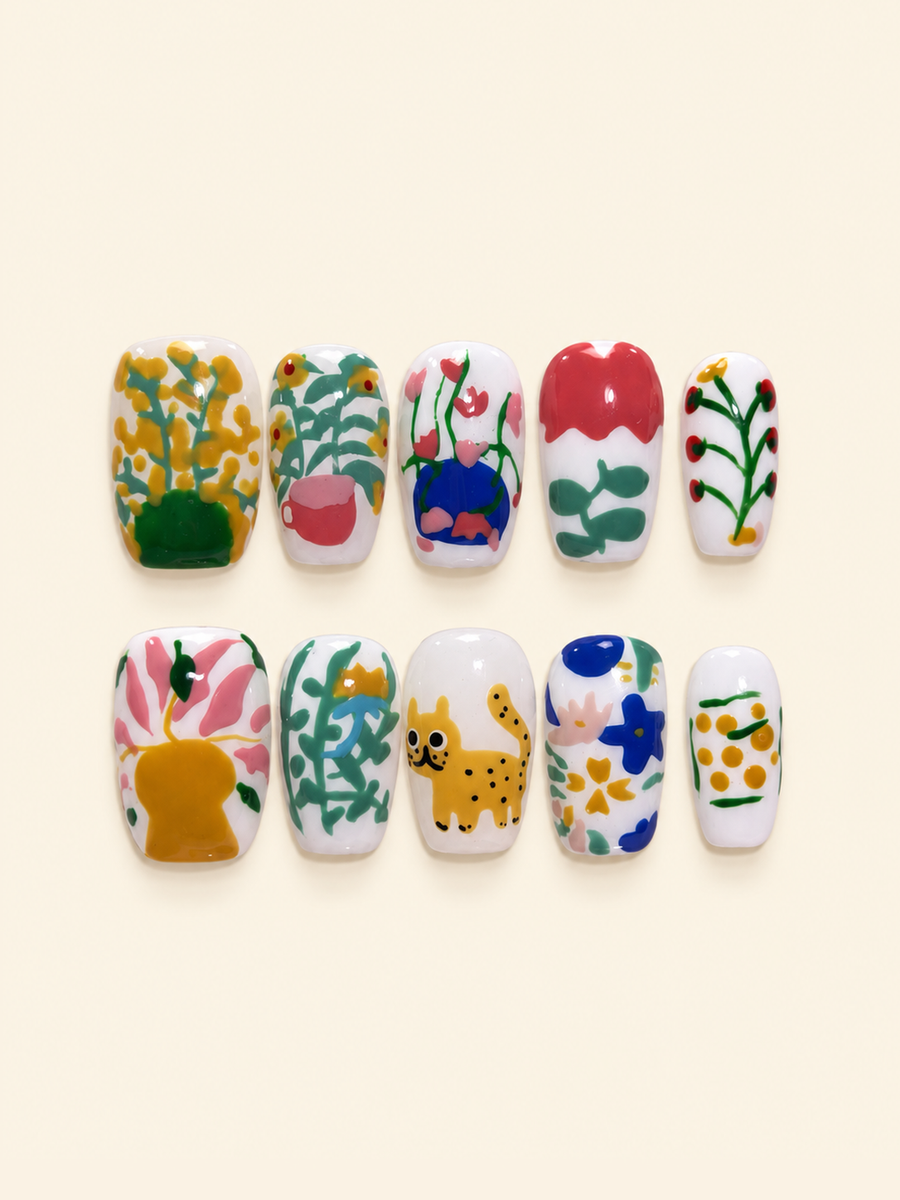 OVANA hand-painted floral and cat press-on nails in yellow, pink, green, blue, and white