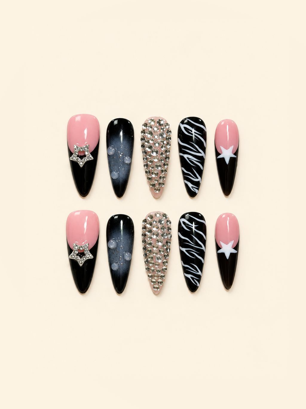 Ten pointed pink and black press-on nails with star accents, rhinestones, smoky ombré, raised droplets, and white swirls