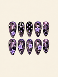 OVANA purple shimmer and black press-on nails with lavender polka dots, 3D stars, and crystal accents