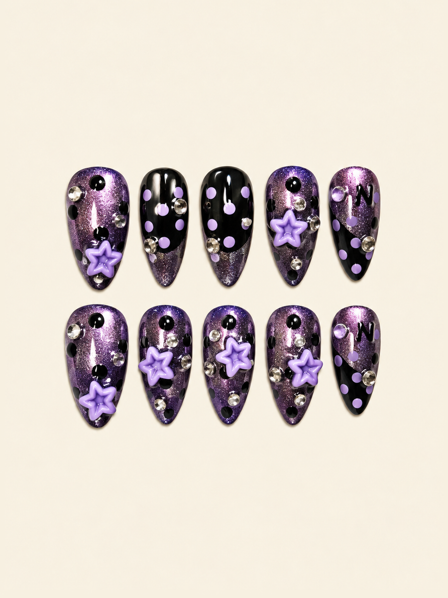 OVANA purple shimmer and black press-on nails with lavender polka dots, 3D stars, and crystal accents
