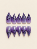 Purple glitter ombré stiletto press-on nails with black leopard print spots